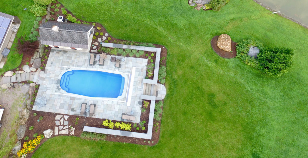 Ariel view of a pool and yard