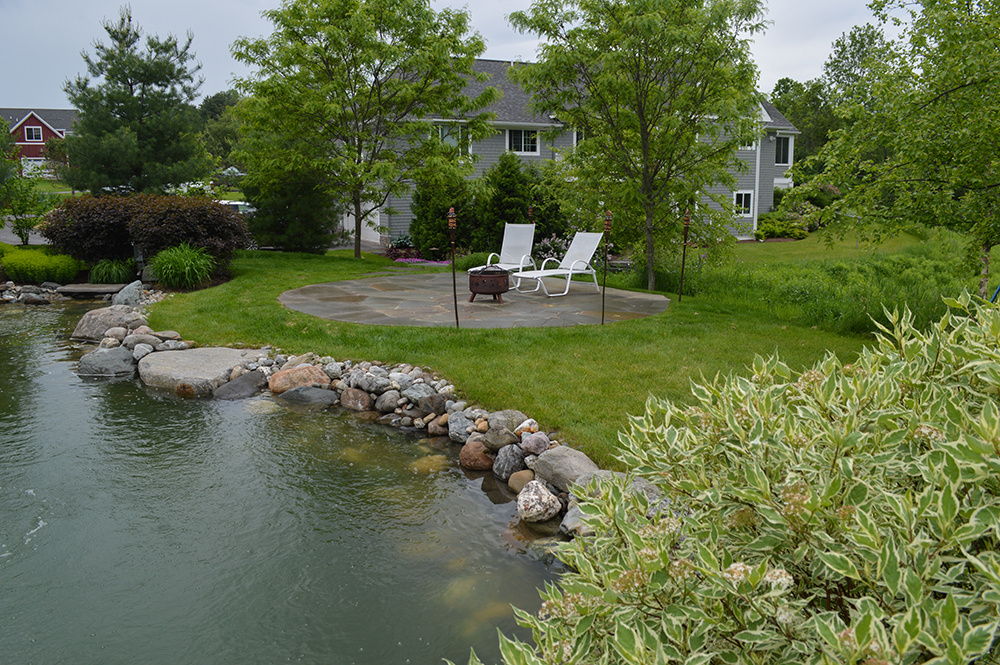 Natural swimming pond with bluestone patio