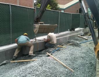 Granite curbs being carefully set in place